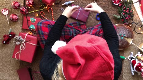 Woman-wrapping-Present-and-Christmas-Flat-Lay