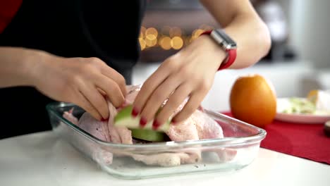 Woman-Preparing-stuffed-duck-for-christmas-dinner