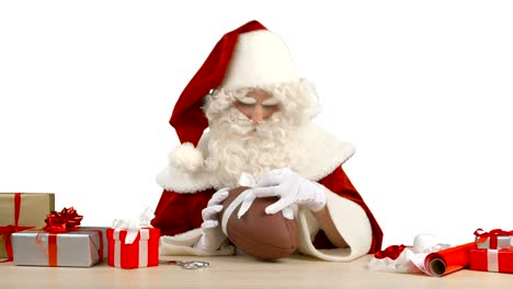 Santa-Claus-is-Tying-a-Bow-on-a-Football