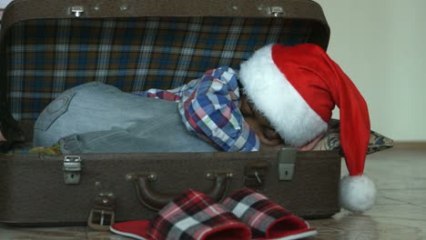 Little-Santa-sleeping-in-suitcase.