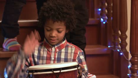 Smiling-boy-playing-on-drum.