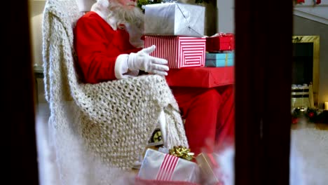 Santa-claus-holding-christmas-gift