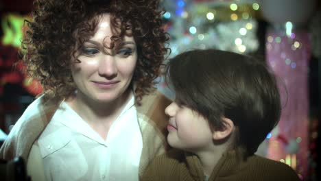 4k-Christmas-and-New-Year-Holiday-Mom-and-Child-at-Fireplace-Posing-Happy