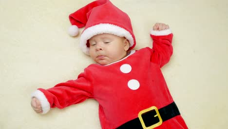 Cute-little-baby-boy-lie-wearing-Santa-Claus-hat.