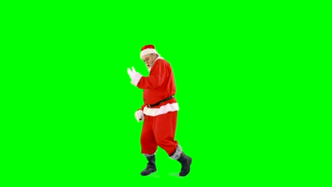 Santa-claus-dancing-against-green-background