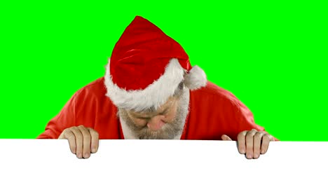 Überrascht-Weihnachtsmann-versteckt-sich-hinter-green-screen