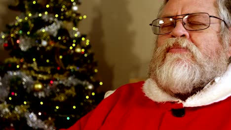 Santa-claus-relaxing-on-chair-having-sweet-food-and-drinking-milk