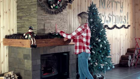 Woman-decorating-fireplace-for-Christmas