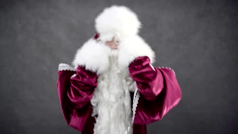 Cheerful-Santa-Claus-dancing-against-black-background