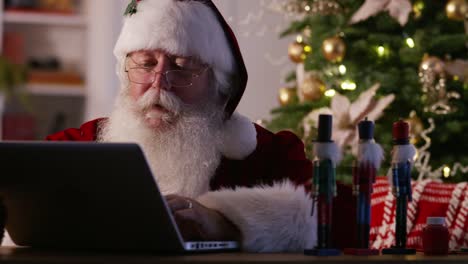 Santa-Claus-in-workshop-using-computer