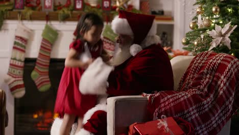 Santa-Claus-gives-present-to-young-girl