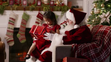 Santa-Claus-gives-present-to-young-girl