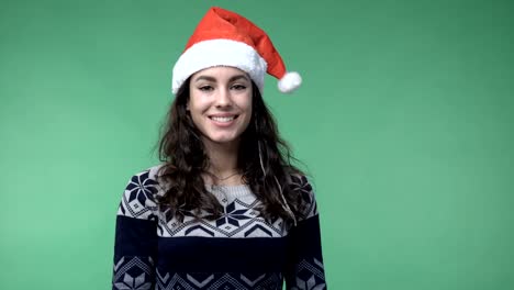 brunette-woman-in-a-red-santa's-cap-smiling