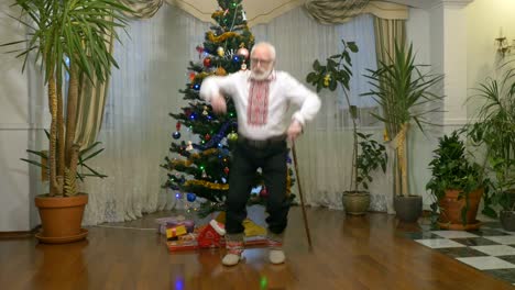 Pleasant-old-man-dances-near-the-christmas-tree