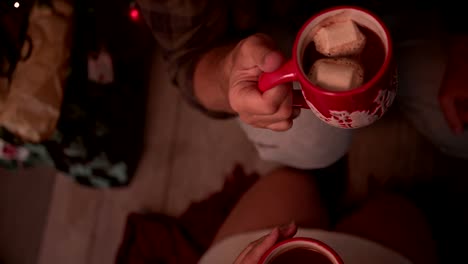 Mature-husband-and-wife-drinking-hot-chocolate-on-Christmas-Eve