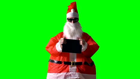 Santa-Claus-enthüllt-einen-neue-coolen-Tablet-PC-auf-einem-grünen-Hintergrund.