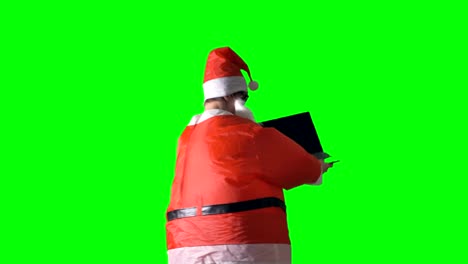 Santa-Claus-dreht-sich-um-und-zeigt-einen-schwarzen-Laptop.