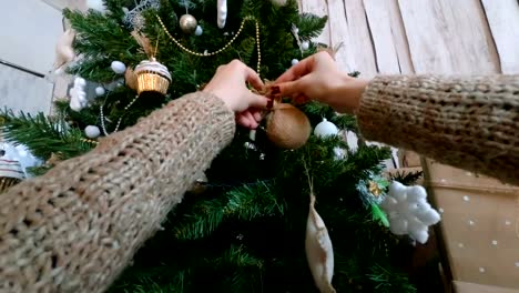 Woman-decorating-christmas-tree-with-toys