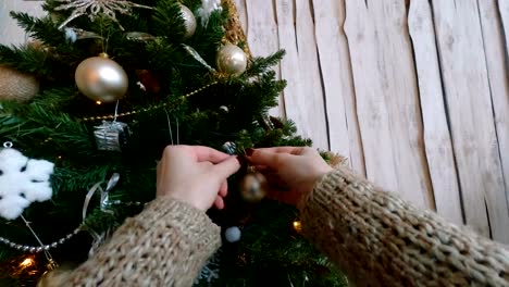 Woman-decorating-christmas-tree-with-toys