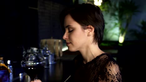 Close-up-portrait-of-a-stunning-young-brunette-woman-enjoying-drinks-at-the-bar-in-the-evening