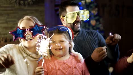 Bright-excited-family-with-sparkles-having-Christmas