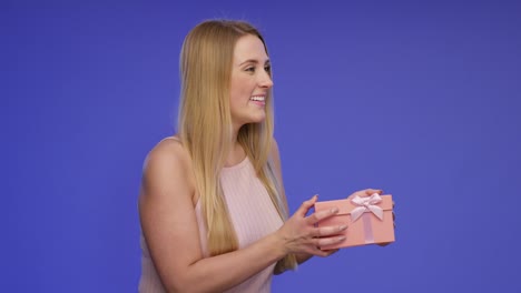 Beautiful-Woman-with-Gift-Box-in-her-Hands-on-Bluescreen