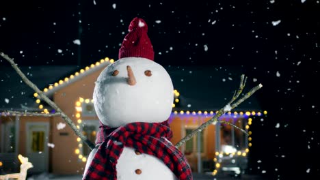 Funny-Snowman-Wearing-Hat-and-Scarf-Standing-in-the-Backyard-of-the-Idyllic-House-Decorated-with-Garlands-on-Christmas-Eve.-Snow-is-Falling-on-that-Magical-Winter-Evening.