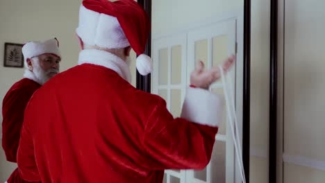 Santa-Claus-wear-his-red-hat,-open-the-door-and-walk-out