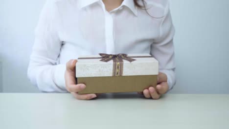 Gift-box-in-the-hands-of-business-women.-Happy-woman-isolated