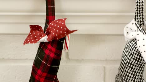 Dolly-shot-in-slow-motion-of-christmas-stockings-hanging-above-the-fireplace