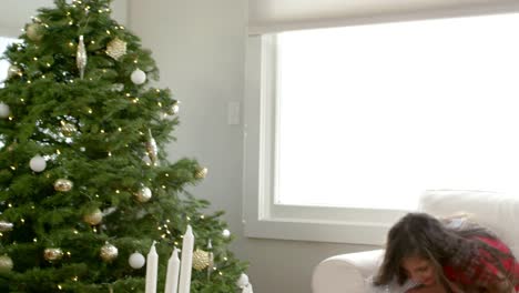 Close-up-of-a-girl-giving-her-family-their-Christmas-presents