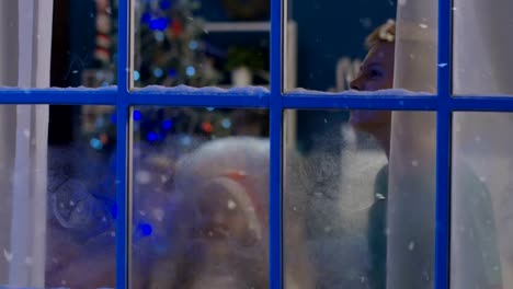 Excited-kids-in-frozen-window-in-Christmas-night