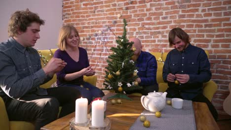 Friends-decorating-small-Christmas-tree