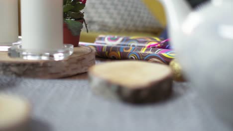 Wrapping-paper,-candle-and-tea-cups-on-table