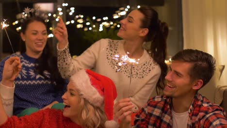 happy-friends-with-sparklers-celebrating-christmas-at-home-party