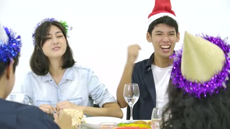 Group-of-asian-people-gathering-at-table-together-and-celebrating-Christmas-with-delicious-meal-at-new-year-party-together.-People-with-holidays-and-celebration-concept.