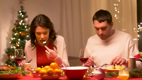 happy-couple-eating-at-christmas-dinner