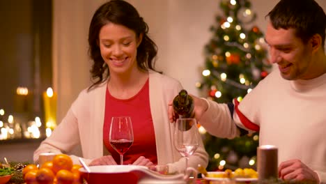 happy-couple-drinking-red-wine-at-christmas-dinner