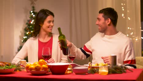 happy-couple-drinking-red-wine-at-christmas-dinner