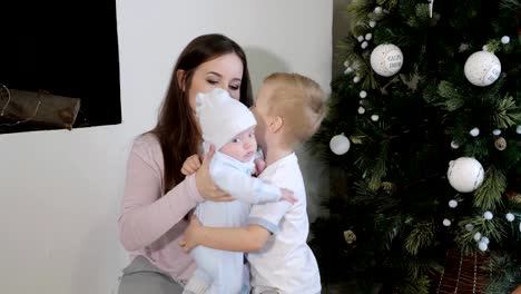 Mother-and-kids-near-Christmas-tree