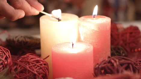 Child's-hand-lighting-Christmas-candles.