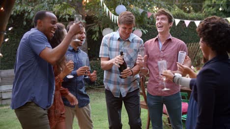 Friends-Celebrating-With-Champagne-At-Outdoor-Backyard-Party