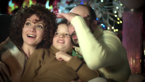 4k-Christmas-and-New-Year-Holiday-Family-at-Fireplace-Looking-Happy