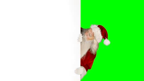 Sorprendido-de-santa-claus-esconderse-detrás-de-pantalla-en-blanco