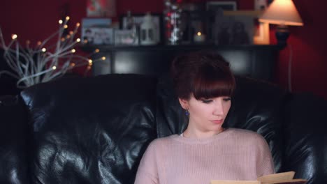 4k-Authentic-Shot-of-a-Woman-Reading-Book-on-Couch