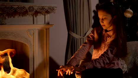 Teen-girl-sitting-near-fireplace