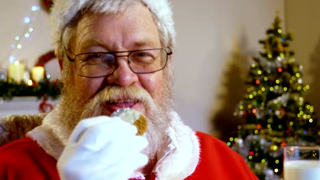 Santa-claus-relaxing-on-chair-and-having-sweet-food