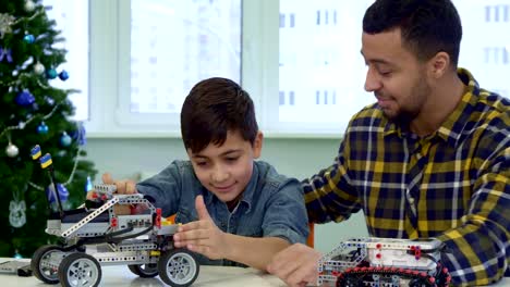 Father-and-son-play-with-toy-SUV