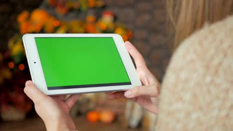 Woman-looking-at-tablet-computer-with-green-screen