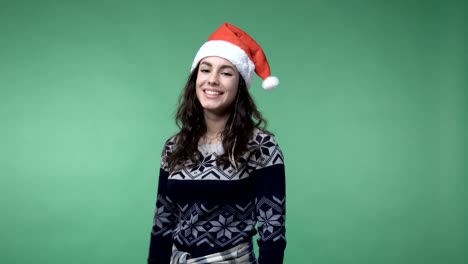 woman-in-santa's-cap-showing-thumb-up-and-smiling